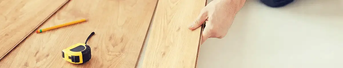 A professional installing wood flooring in Albuquerque, NM