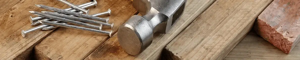 Hammer and nails on hardwood flooring boards in Albuquerque, NM