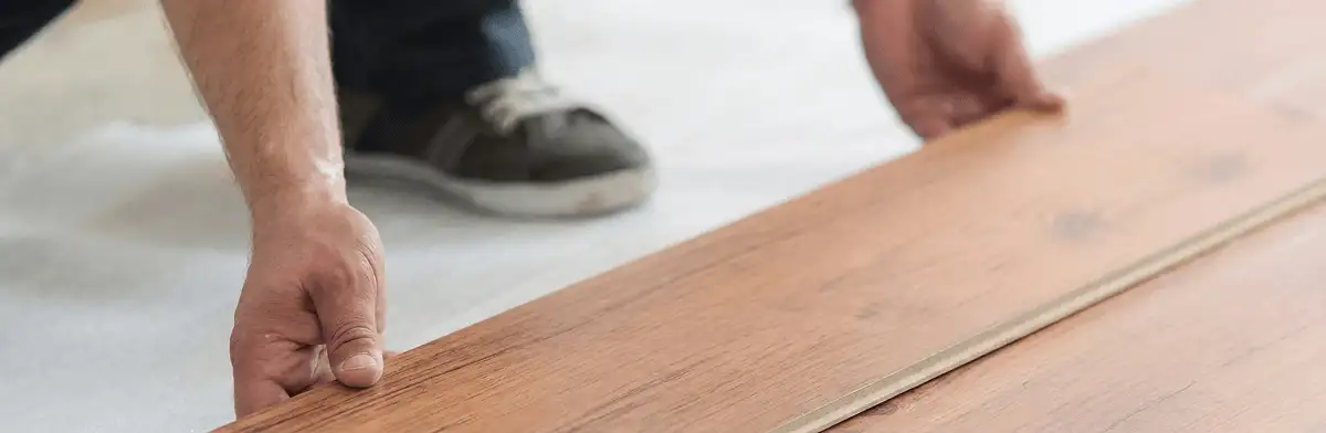 A professional installing laminate flooring in Albuquerque, NM