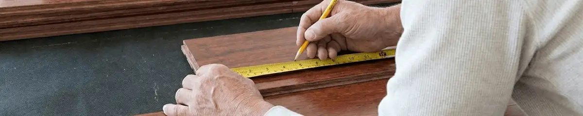 A professional installing wood flooring in Albuquerque, NM